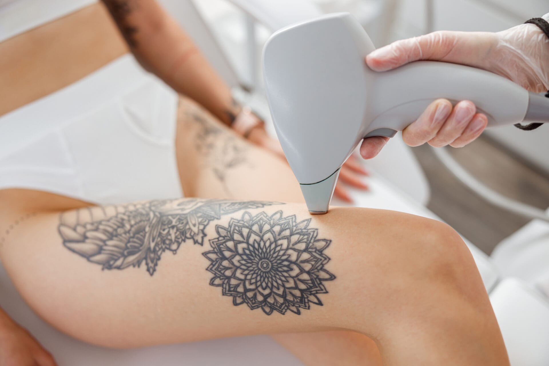 Female cosmetologist performing laser hair removal procedure