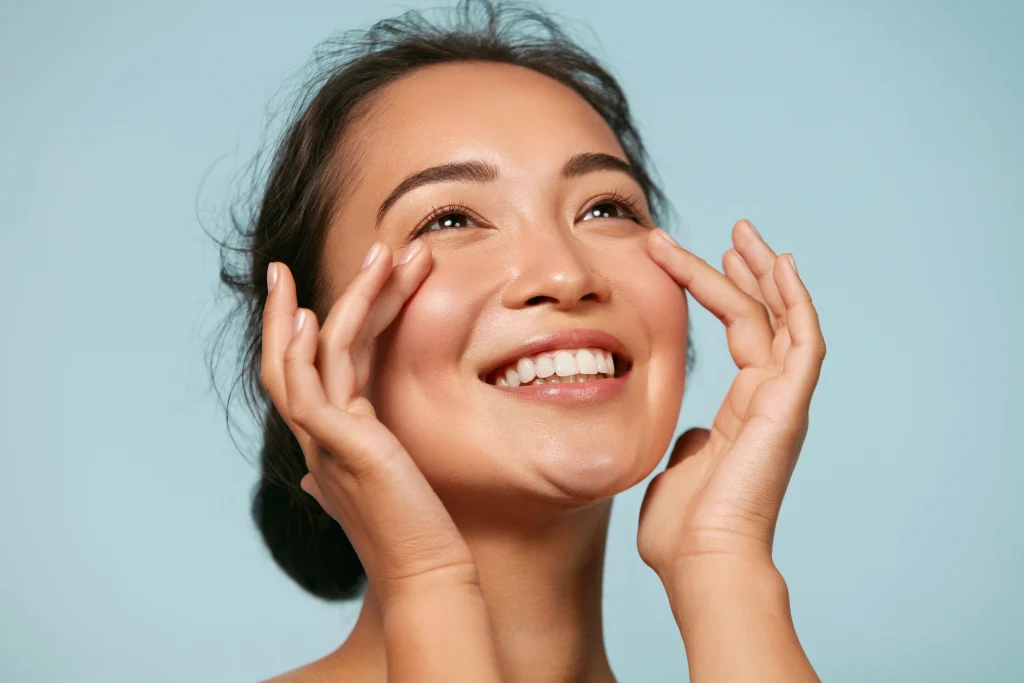 Woman touching under-eye area for facial rejuvenation treatment